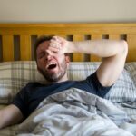 Person waking up in bed.